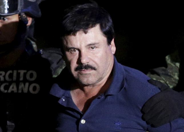 Recaptured drug lord Joaquin “El Chapo” Guzman is escorted by soldiers at the hangar belonging to the office of the Attorney General in Mexico City