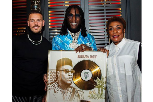 Burna Boy receives a plaque after his song, 'On The Low' went Gold In France
